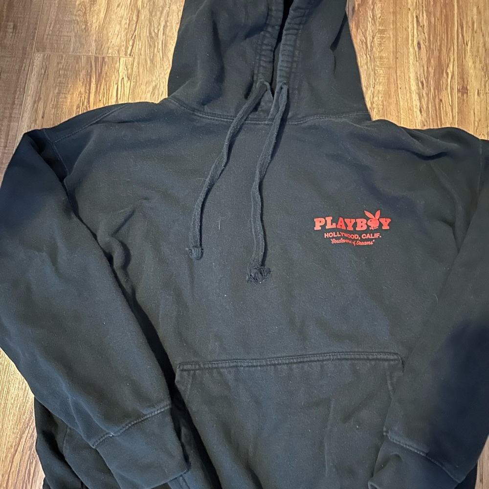 Small black playboy hoodie with red lettering and graphic on the back